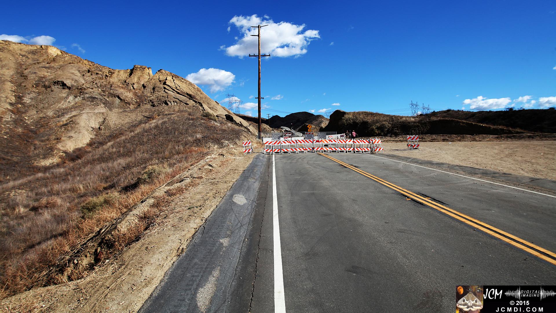 Landslide, buckled pavement, and terrain at Vasquez Canyon Road in Santa Clarita, CA filmed 11-25-2015